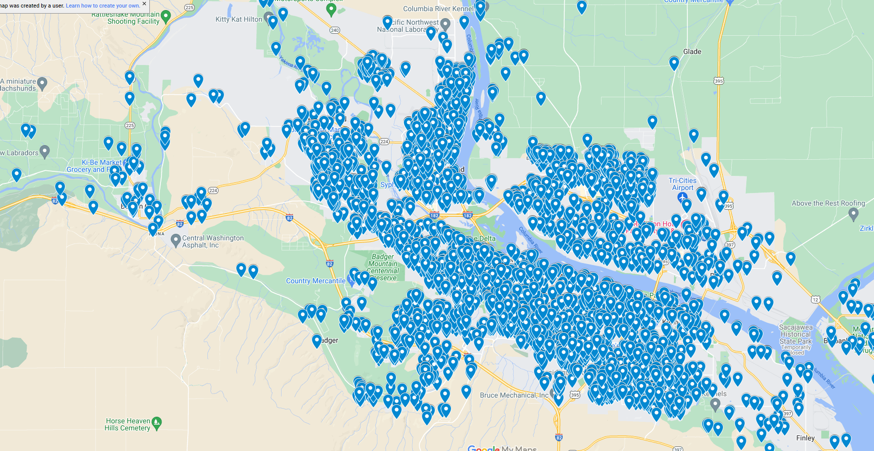 A digital map displaying a concentrated cluster of blue location markers, primarily centered around a river that runs horizontally across the image. The markers suggest numerous points of interest or data points, possibly highlighting locations offering commercial painting services in that region.